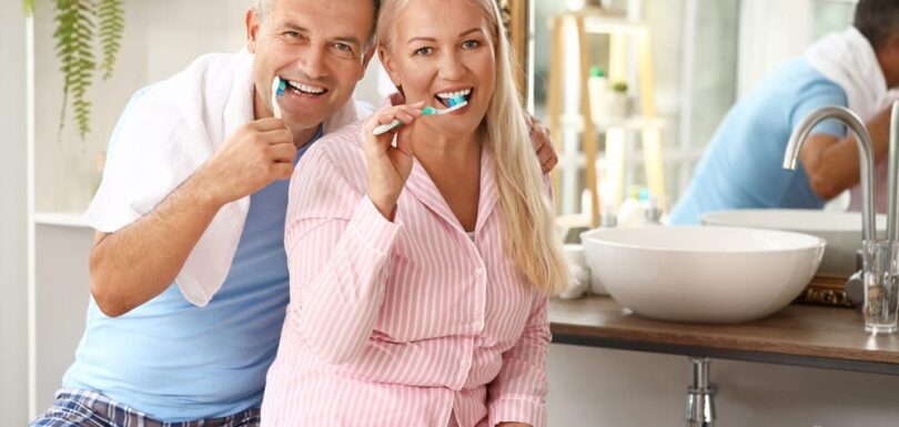 Mature couple brushing teeth at home